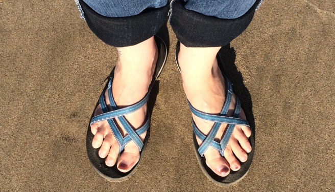 sandaled feet on the sandy beach